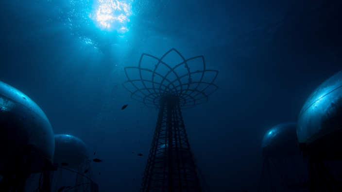 Under water, everything is blue. At the top left, the light reflects. You can see bubbles and a few small fish. In the middle there is a metal scaffold in the shape of a tower. The top is a metal flower. On the left and the right side of the picture there are two big plastic balls.