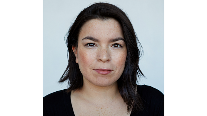 A portrait photo of the poet Natasha Kanapé Fontaine. She has half-length dark hair and is looking into the camera.