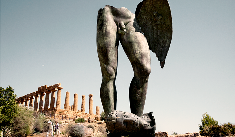 A bronze statue designed by the Polish sculptor Igor Mitoraj in front of the ruins of the ancient city of Agrigento in Sicily