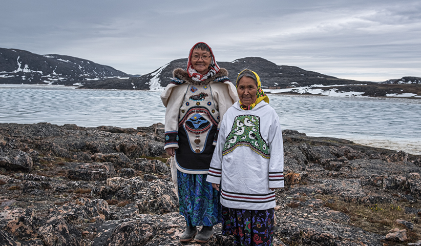 Two residents of Cape Dorset pose in traditional dress during the Aboriginal Day festival